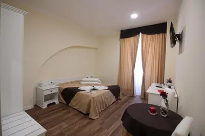 a hotel room with a bed and a table at Freedom Love B&B in Rome