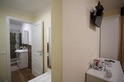 a white bathroom with a sink and a toilet at Freedom Love B&B in Rome