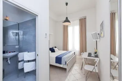 a bedroom with a bed and a bathroom with a sink at San Peter Angels in Rome
