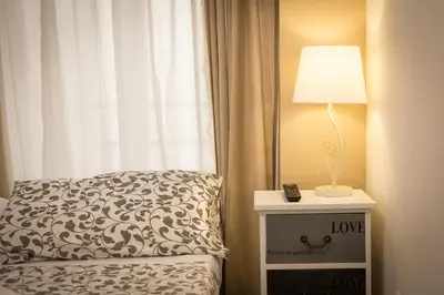 a bedroom with a bed and a lamp on a night stand at San Peter Angels in Rome