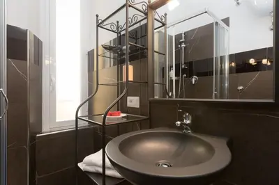 a bathroom with a sink and a mirror at San Peter Angels in Rome