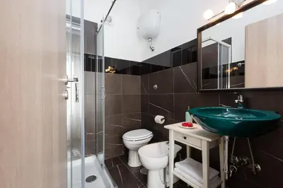a bathroom with a sink and a toilet and a shower at San Peter Angels in Rome