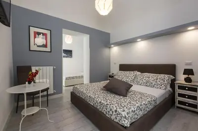 a bedroom with a bed and a table in it at San Peter Angels in Rome