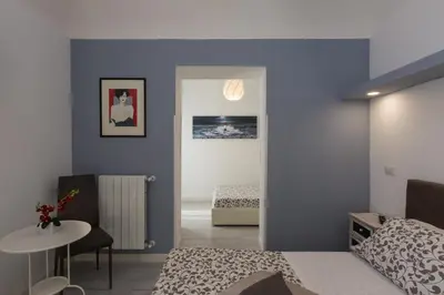 a bedroom with blue walls and a bed and a table at San Peter Angels in Rome