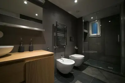 a bathroom with a sink and a toilet and a shower at San Lorenzo 42 in Rome