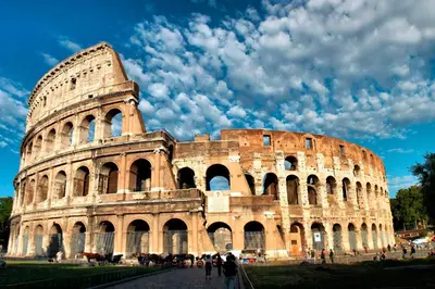 a large building with people standing in front of it at White Rooms Colosseo in Rome