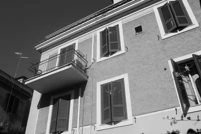 a black and white photo of a building with windows at St. John Villa in Rome