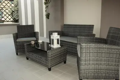 three wicker chairs and a table in a room at St. John Villa in Rome