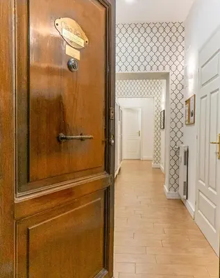 a light hanging from a wall with a snake pattern at Ciao Bella Apartment in Rome