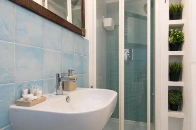 a bathroom with a white sink and a shower at Navona Open Space Apartments in Rome