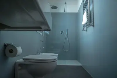 a white bathroom with a toilet and a sink at Navona Open Space Apartments in Rome