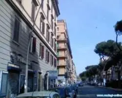 a city street with buildings and cars parked on the street at Domus Appia 154 B&B in Rome
