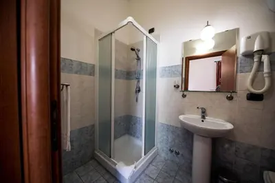 a bathroom with a shower and a sink at Domus Appia 154 B&B in Rome