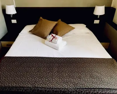 a bed with a white box with a bow on it at Domus Appia 154 B&B in Rome