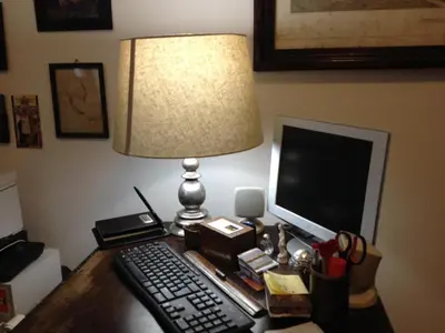 a desk with a lamp and a keyboard and a computer at Domus Appia 154 B&B in Rome