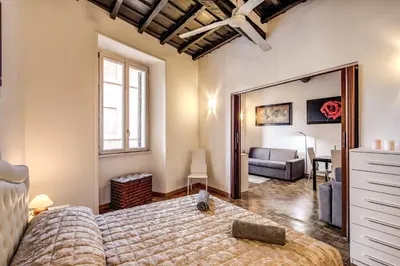 a bedroom with a large bed and a mirror at Casa Monticelli in Rome