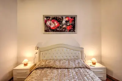 a bedroom with a bed with two night stands and two lamps at Casa Monticelli in Rome