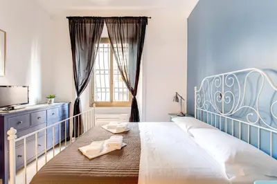 a bedroom with a large bed and a window at Locanderia Roma in Rome