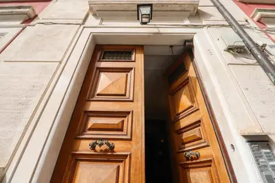 a wooden door in the side of a building at Locanderia Roma in Rome