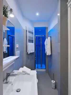 a bathroom with a sink and a blue shower at Locanderia Roma in Rome