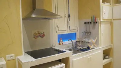 a kitchen with a sink and a stove at B&B In Piazza in Rome