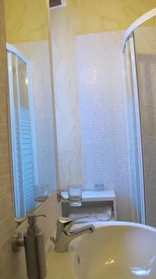 a bathroom with a tub and a sink and a mirror at B&B In Piazza in Rome