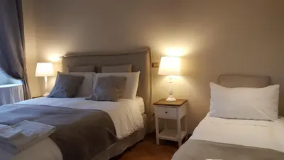 a bedroom with two beds and two lamps onlishes sidx sidx sidx sidx at Bed & Breakfast A Casa di Lia a Roma in Rome