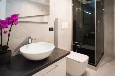 a bathroom with a white sink and a toilet at Erida Apartment Spanish Steps in Rome