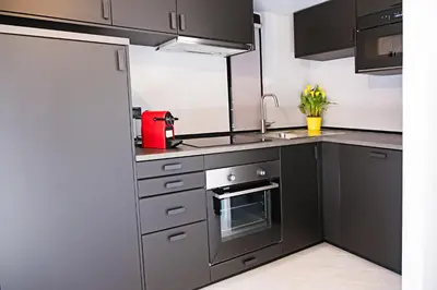 a kitchen with stainless steel appliances and a sink at Erida Apartment Spanish Steps in Rome