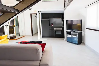a living room with a couch and a flat screen tv at Erida Apartment Spanish Steps in Rome