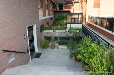 a courtyard of a building with potted plants at B&B St. Peter's Suites in Rome