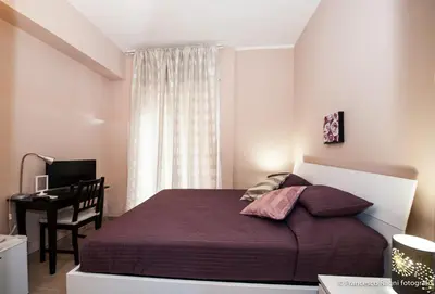 a small bedroom with a bed and a desk at B&B St. Peter's Suites in Rome