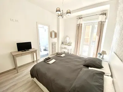 a bedroom with a large bed and a television at A Quattro Passi Da in Rome