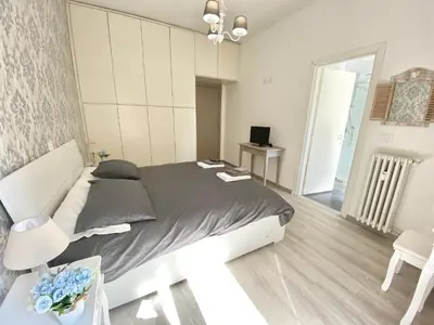 a bedroom with a bed and a table and chairs at A Quattro Passi Da in Rome