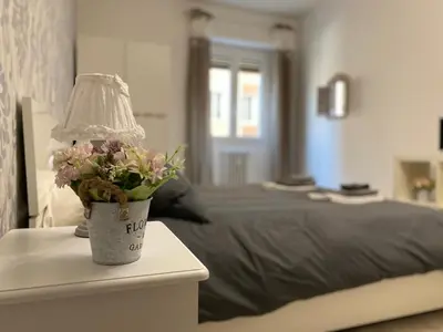 a lamp on a table next to a bed at A Quattro Passi Da in Rome