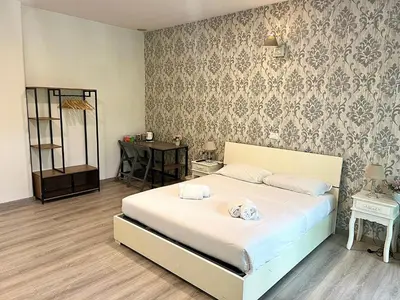 a bedroom with a bed and a table with a mirror at A Quattro Passi Da in Rome