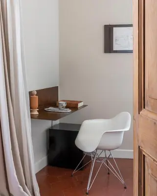 a white chair in a room with a table at MyNavona in Rome