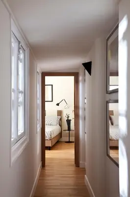 a hallway with a bedroom with a bed and a window at MyNavona in Rome