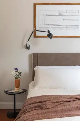 a bedroom with a bed and a table with a lamp at MyNavona in Rome