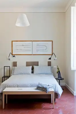 a bedroom with a large bed with two lamps at MyNavona in Rome