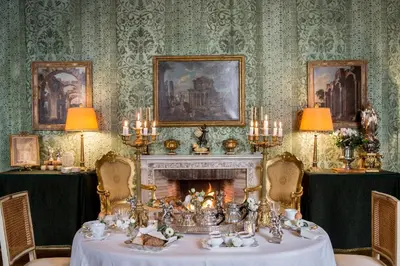 a dining room with a table and a fireplace at Residenza Napoleone III in Rome
