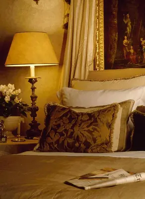 a bedroom with a bed with a pillow and a lamp at Residenza Napoleone III in Rome
