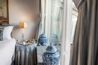 a bedroom with blue and white vases next to a window at Residenza Napoleone III in Rome
