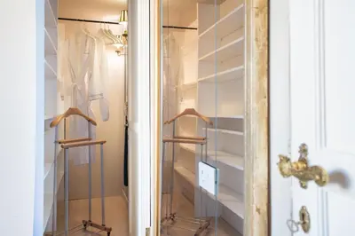 a closet with glass shelves and a door at Residenza Napoleone III in Rome