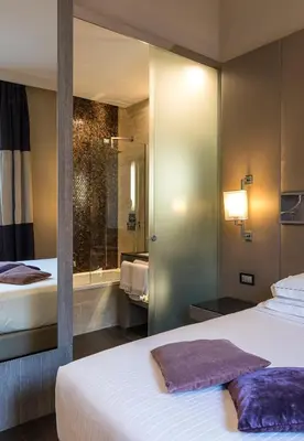 a hotel room with two beds and a shower at Rome Life Hotel in Rome