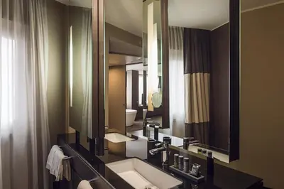 a bathroom with a sink and a large mirror at Rome Life Hotel in Rome