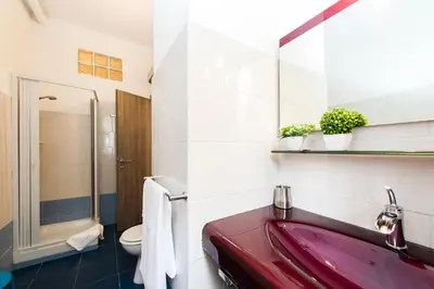 a bathroom with a red sink and a toilet at Domus Fabiola - Vaticano in Rome