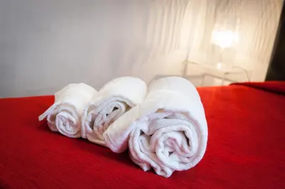 a pile of towels sitting on top of a bed at Domus Fabiola - Vaticano in Rome