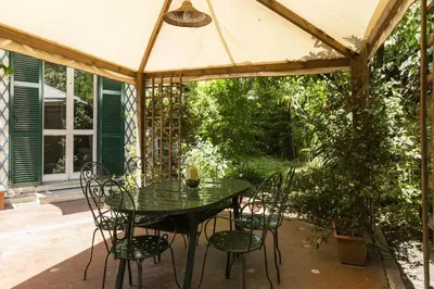 a table and chairs under an umbrella on a patio at Lemon Tree Apartment Sistine Chapel in Rome