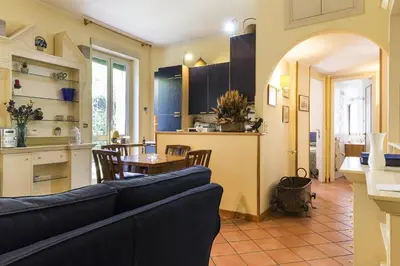 a living room and kitchen with a couch and a table at Lemon Tree Apartment Sistine Chapel in Rome